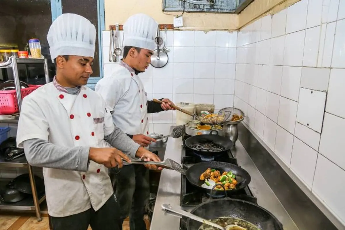 Two chefs cooking in the hotel kitchen