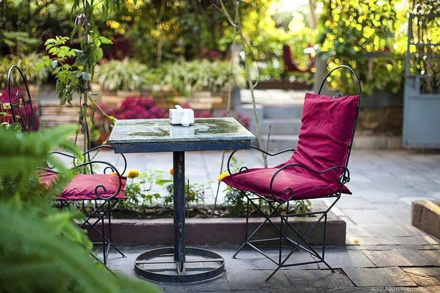 Garden table among flowers at The Silver Oaks Inn, Pokhara