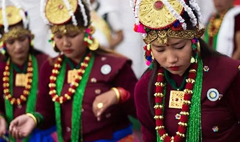 Young Gurung women in festival headdresses and coral necklaces performing Ghatu