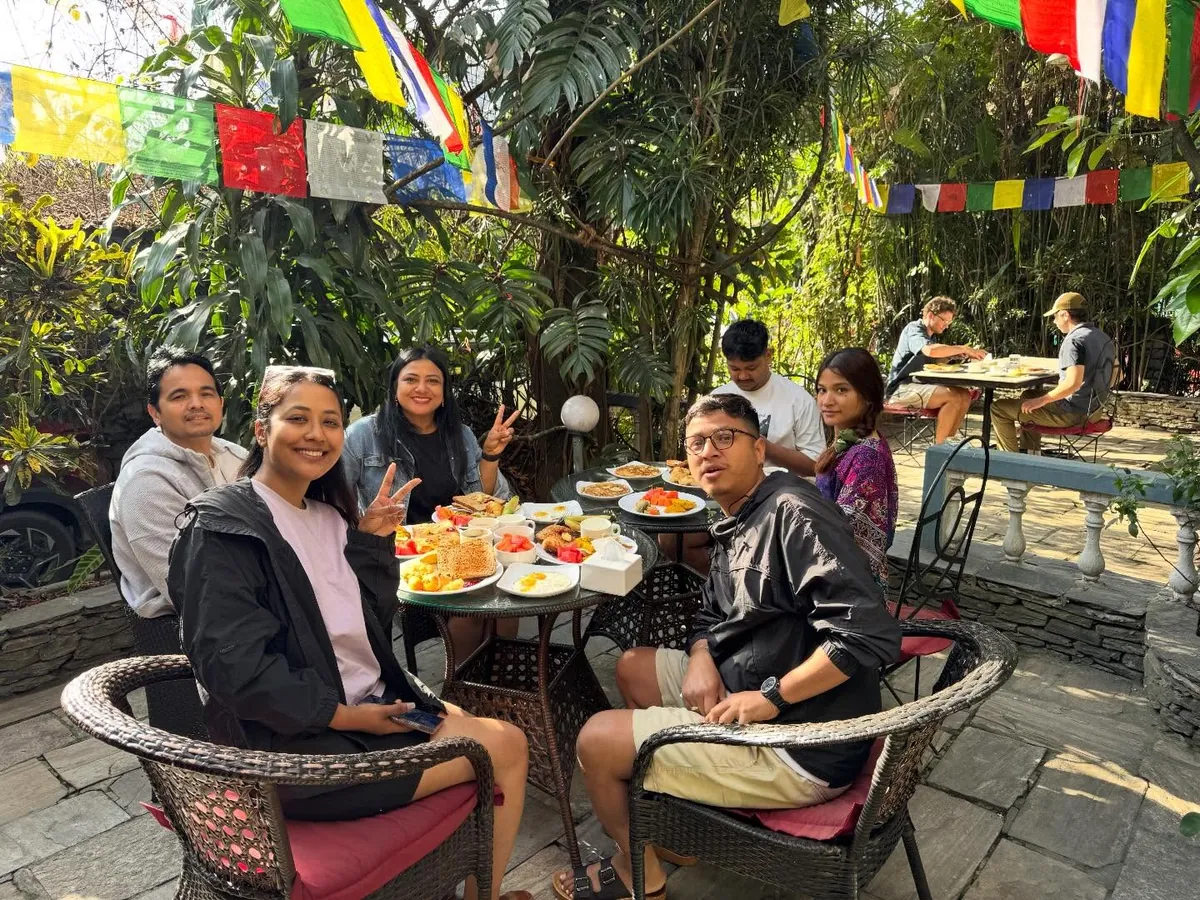 Breakfast under the prayer flags at The Silver Oaks Inn, Pokhara