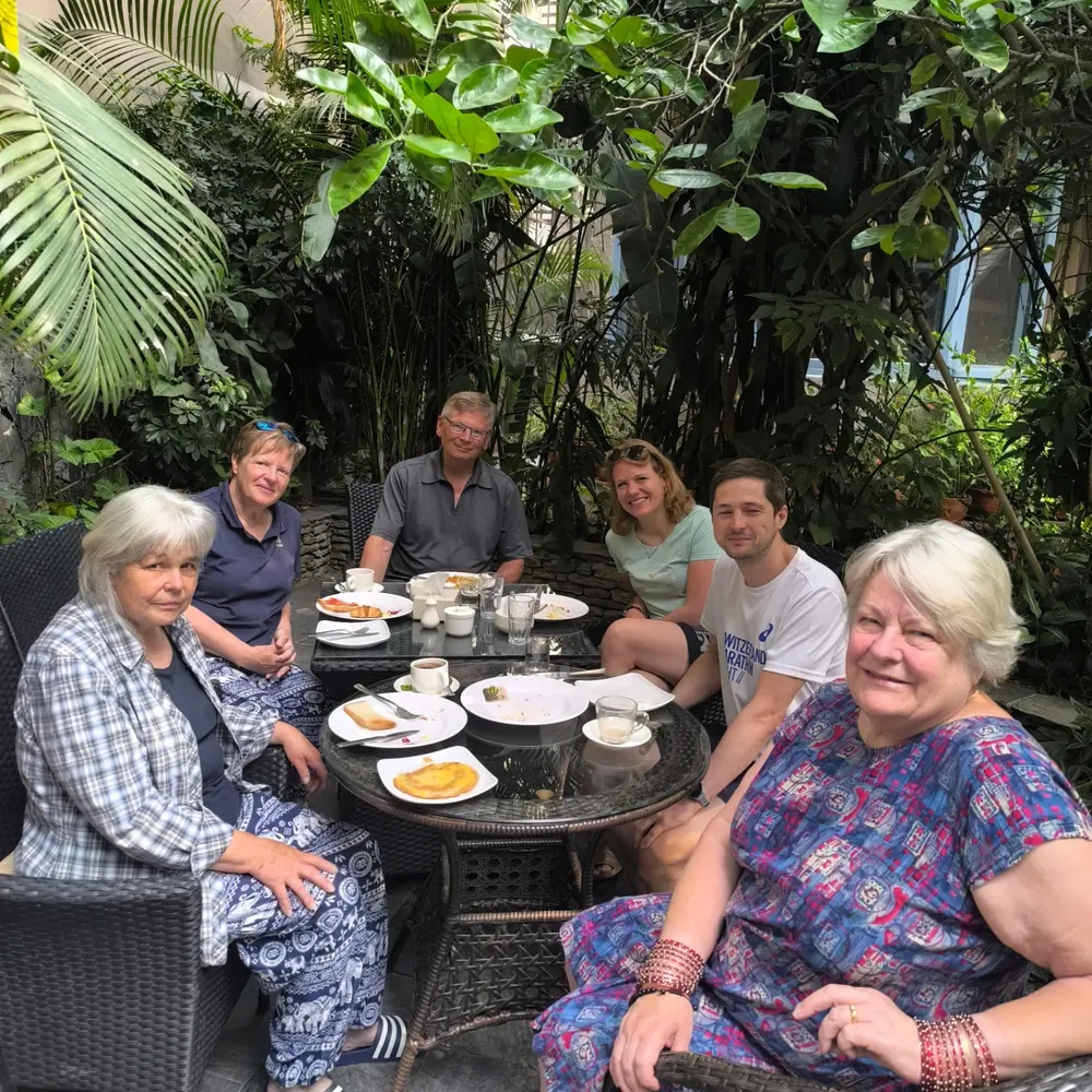 Guests at breakfast in the garden at The Silver Oaks Inn, Pokhara