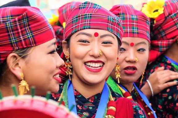 Gurung women in red check headscarves celebrating Tamu Lhosar