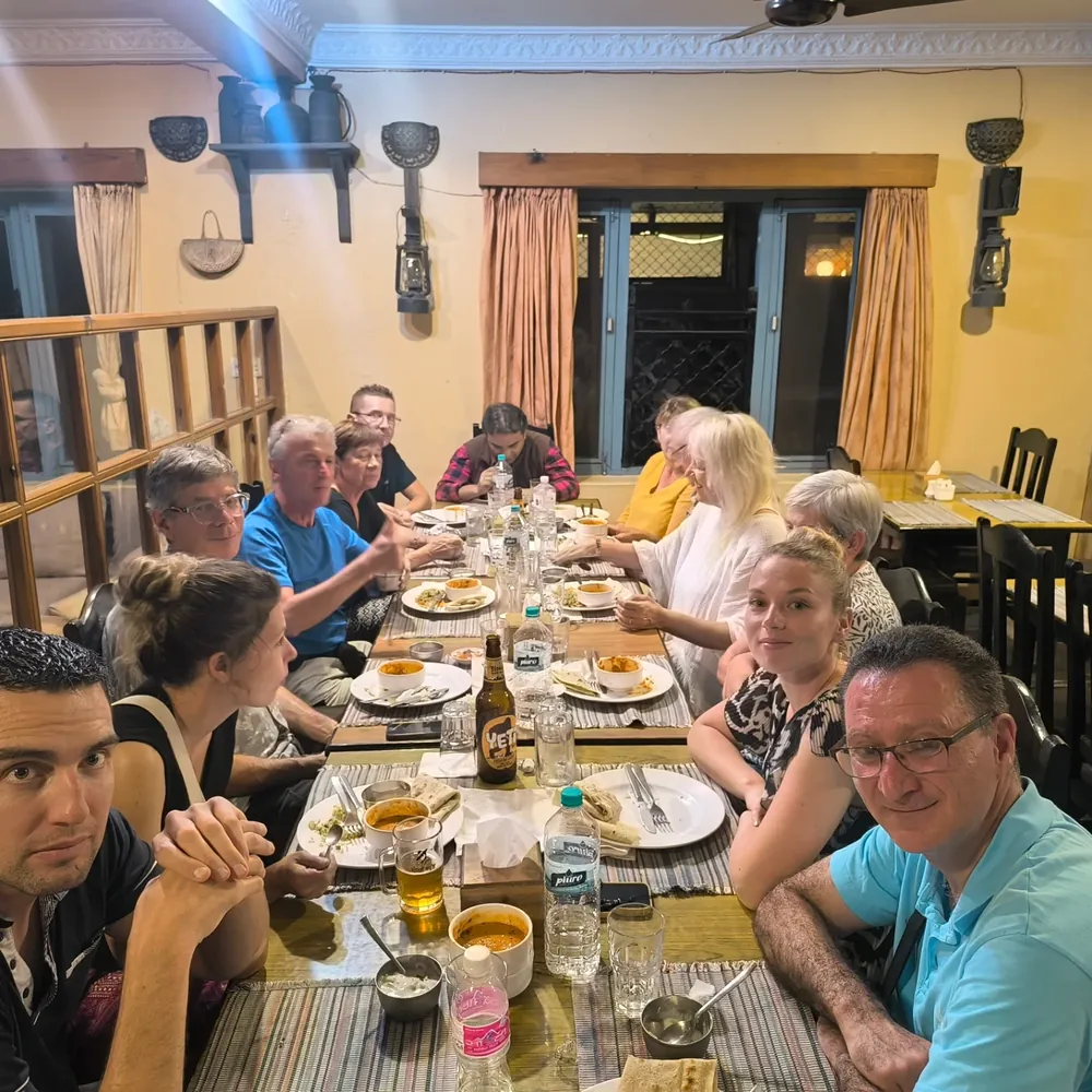 Guests sharing dinner at a long table
