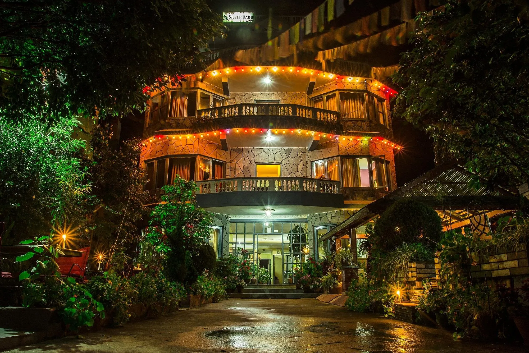 The hotel building lit up at night at The Silver Oaks Inn, Pokhara