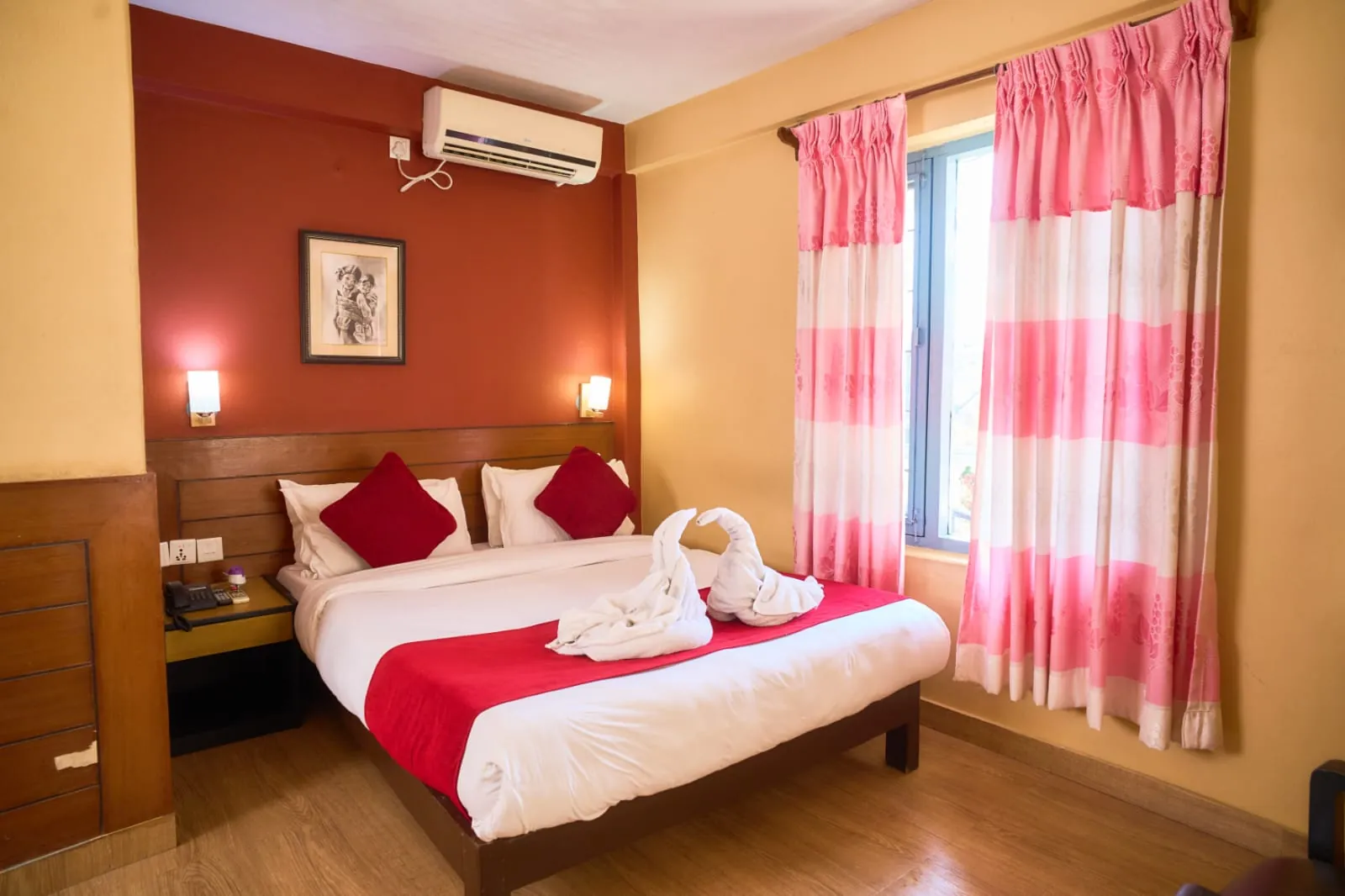 Room with a double and a single bed and bright curtains