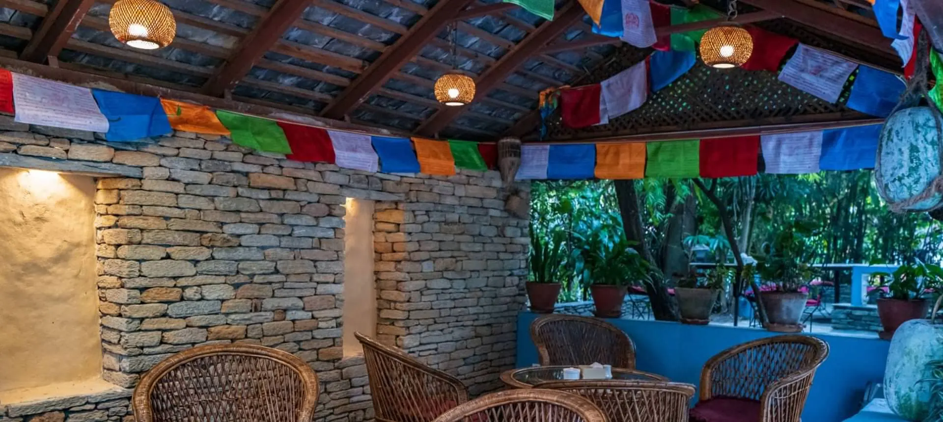 Stone pavilion with prayer flags at The Silver Oaks Inn, Pokhara